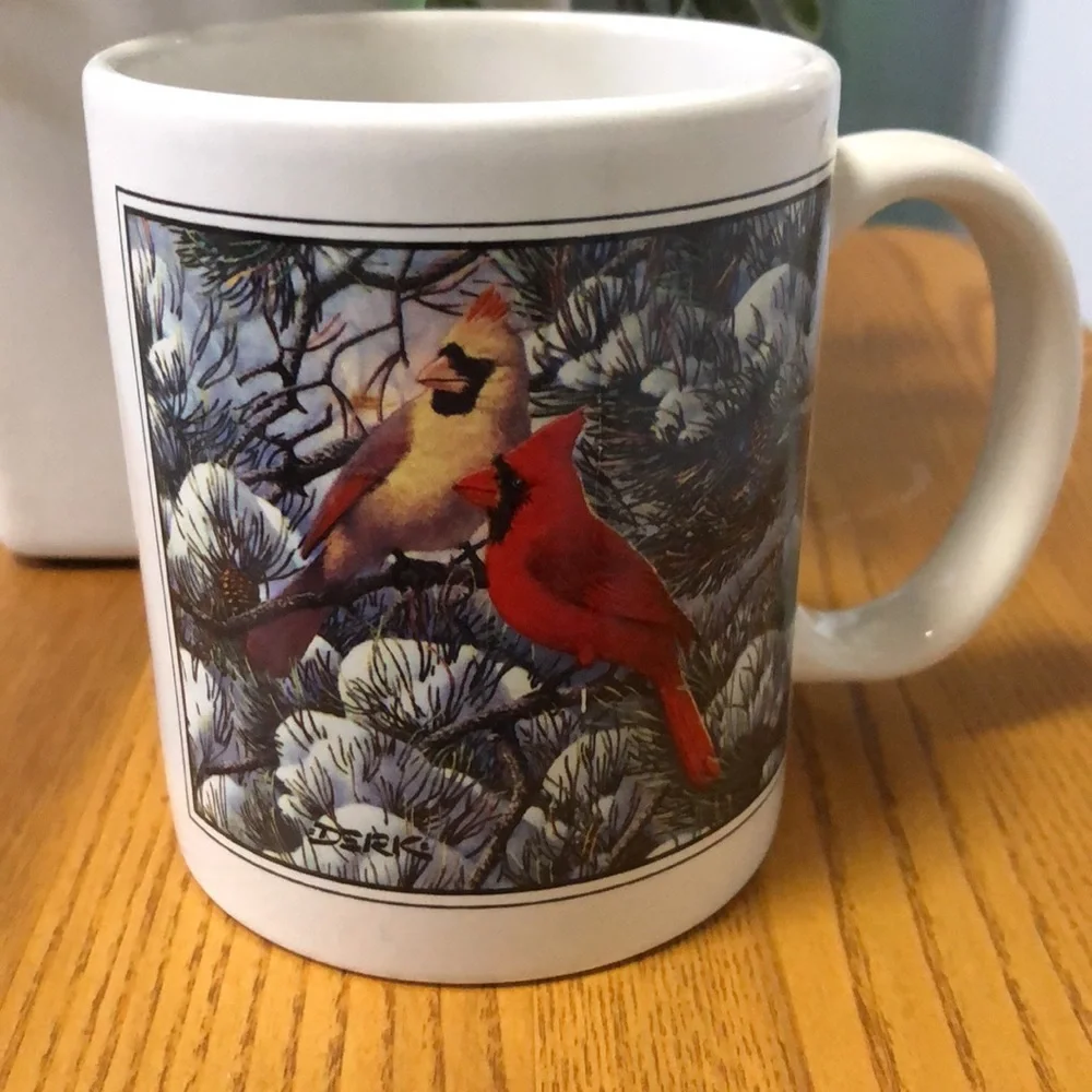 Coffe cup with cardinals in winter scene